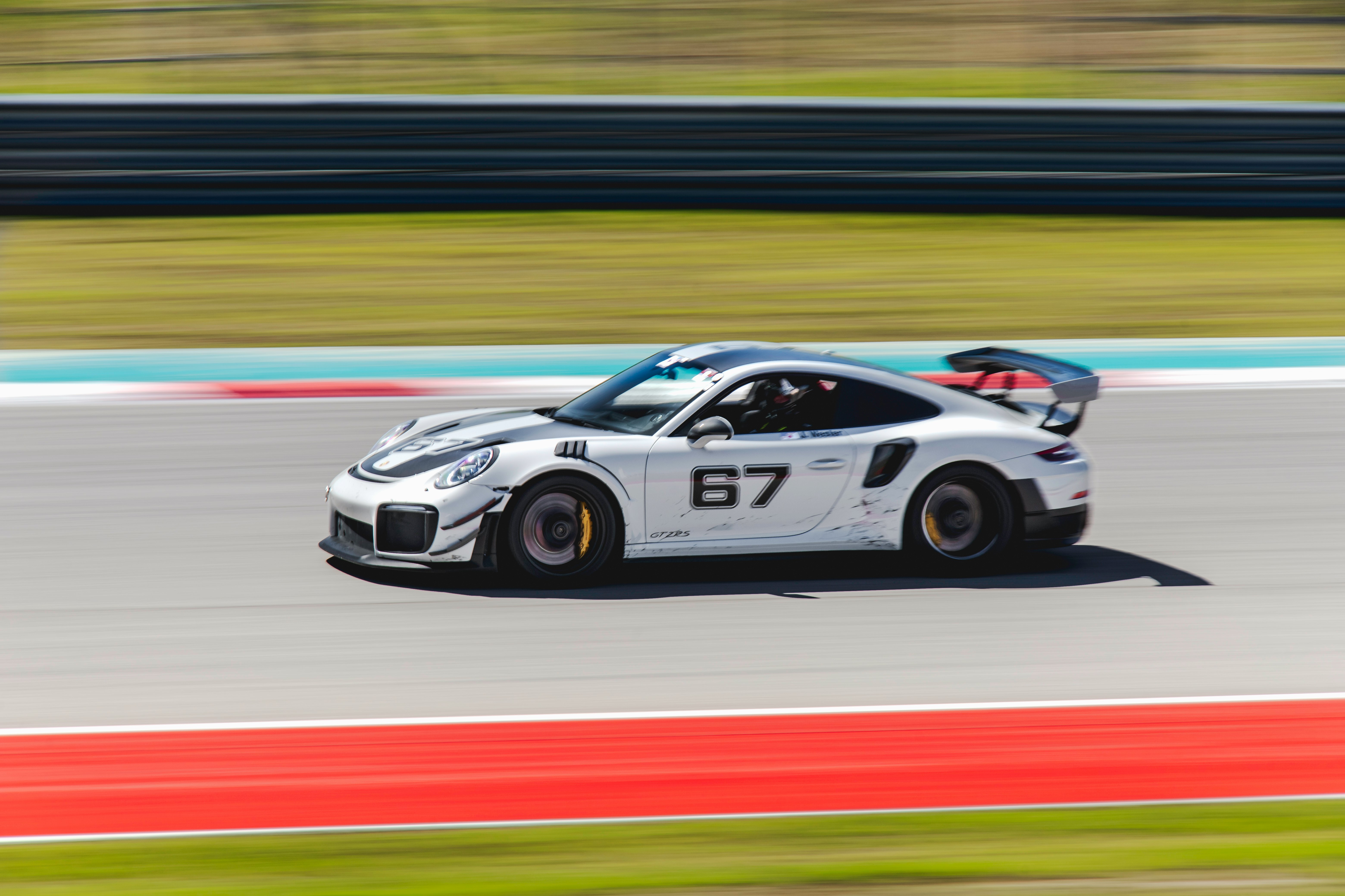 white and black porsche 911 on track